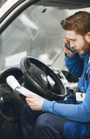 Man in the truck. Guy in a delivery uniform. Man with clipboard.
